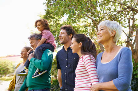 Family is important to them. Shot of a family standing outdoors in the shade.の写真素材