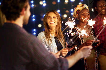 Life is a party once you realise it is. Cropped shot of a group of friends having fun at a...