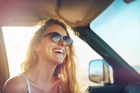 Having fun on the open road. Cropped shot of an attractive young woman on a roadtrip.