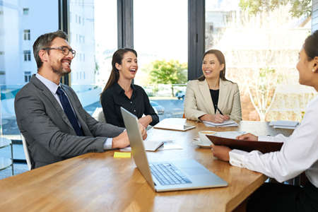 Theyre all smiles in the boardroom. Cropped shot of a group of businesspeople meeting in the...