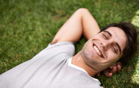 Nature is so relaxing. High angle portrait of a young man relaxing outdoors.