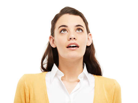 Wow Whats that up there. Young woman looking up against a white background.