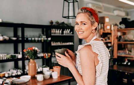 Coffee helps me get through the day. Cropped portrait of an attractive mature woman sitting alone...