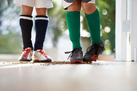 Oops Moms not going to be happy about that. Cropped shot of two boys in sports clothing standing in...