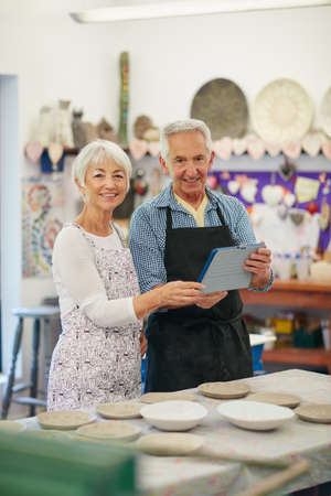 Our online pottery business is now live. Shot of a senior couple working with ceramics in a...
