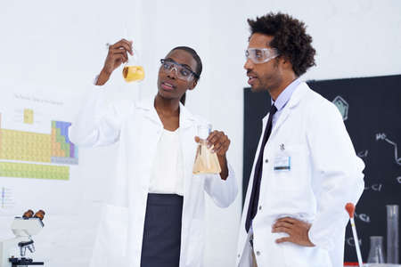 Making science breakthroughs. Shot of two scientists conducting an experiment in their lab.の写真素材