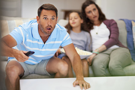 They dont know what theyre missing. Cropped shot of a family sitting on the sofa at home.の写真素材