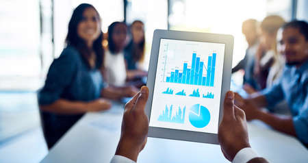 His team is going to love these numbers. Shot of an unidentifiable businessman holding up a tablet...