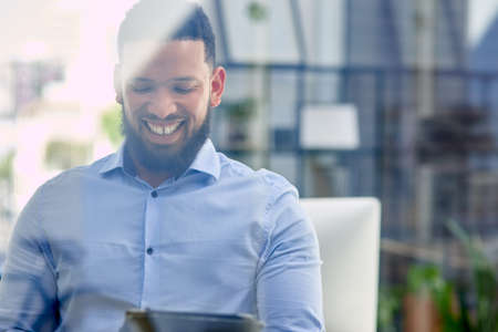 Seeing my business take off makes me happy. Cropped shot of a handsome young businessman sitting...