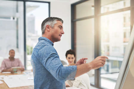 Getting his team up to speed. Cropped shot of a mature businessman giving a presentation.