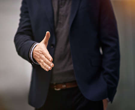Trust is the first step to success. Cropped shot of a businessman extending his arm for a handshake.の写真素材