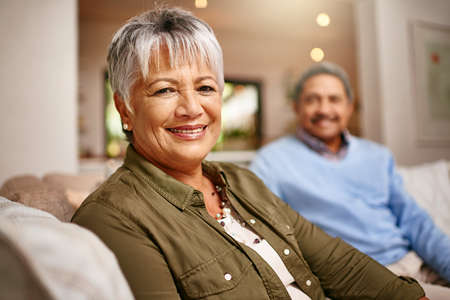 We did good. Portrait of a happy older woman relaxing on the sofa with her husband in the...