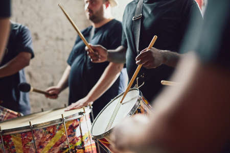 Can you feel the beat. Closeup shot of a musical performer playing drums with his band.の写真素材
