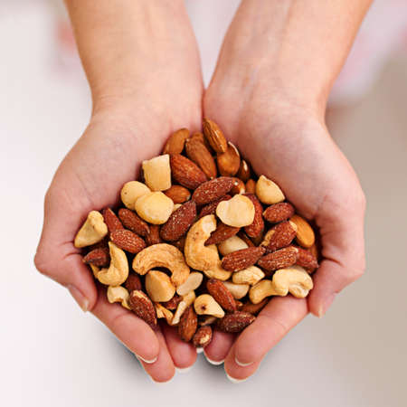 Nuts about nuts. Cropped shot of a bunch of mixed nuts in a persons cupped hands.の写真素材