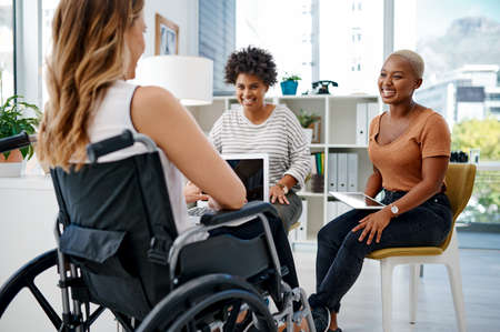 They always come up with the best ideas together. Shot of a businesswoman with disabilities sitting...