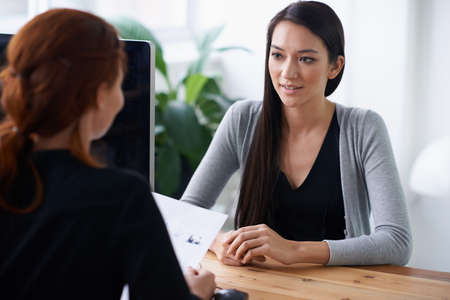 Tell me something about yourself thats not in your resume. Shot of two young professionals having a...