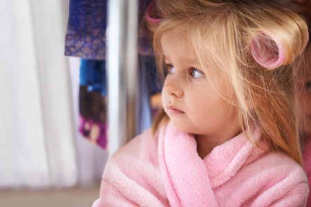 Kids have it easy. Cropped shot of a young girl in a bathrobe.の写真素材