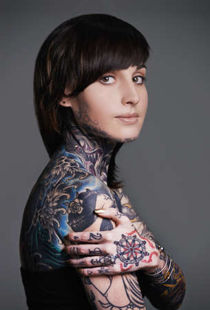Be an original, everyone else is already taken. A cropped studio portrait of a tattooed young woman.の写真素材
