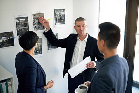 This is what I mean.... Cropped shot of three colleagues working in the office.