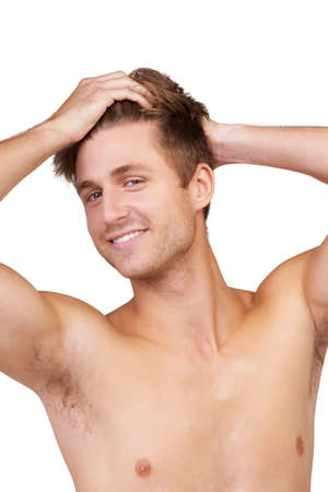 I love my hair. Portrait of a handsome young man with his hands in his hair.の写真素材