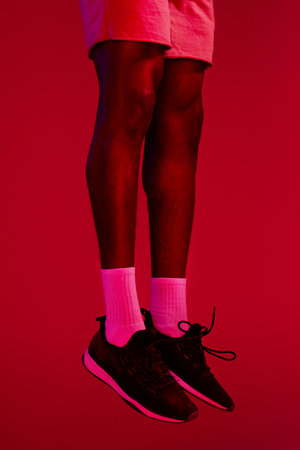 The shoes determine the outcome. Re filtered shot of an unrecognizable man wearing his workout sneakers.の写真素材