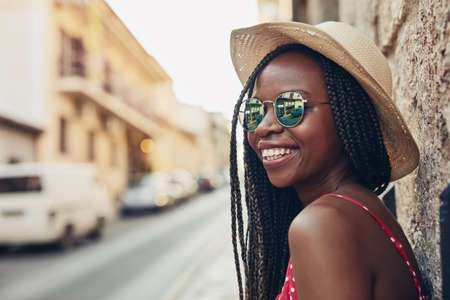 Spending her free time somewhere shes never been before. Shot of a beautiful young woman spending her day out exploring a foreign city.の写真素材