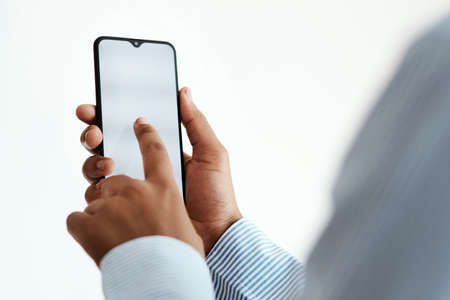 Making business moves in mobile format. Cropped studio sot of an unrecognisable businesswoman using...