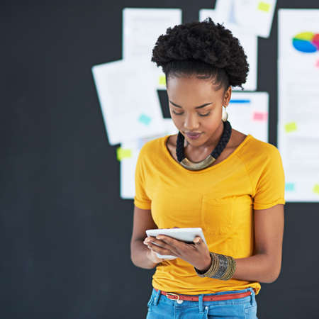 Technology gives her a competitive advantage. Cropped shot of a young creative businesswoman looking...