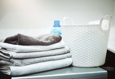 Keeping laundry clean and fresh. Still life shot of linen and a laundry basket on a washing machine.の写真素材