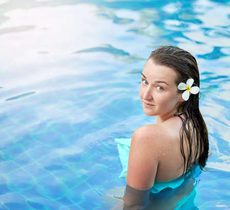 Enjoying a day of leisure and luxury. Portrait of a young woman relaxing in the pool at a spa.