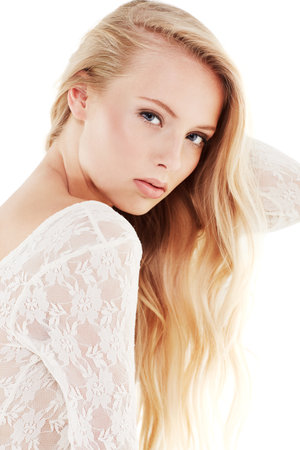 Shes a beauty in all white. Portrait of a beautiful young woman in a white dress.の写真素材