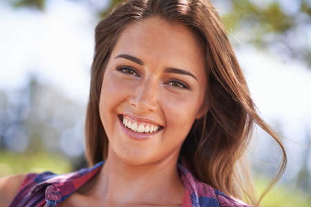 Sexy summer beauty. A beautiful young woman smiling outdoors.