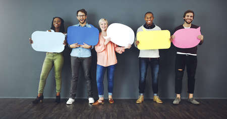 Speak your mind. Studio shot of a diverse group of people holding up speech bubbles against a gray background.の写真素材