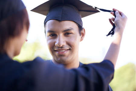 The day has come. A smiling graduate with his graduation hat on.の写真素材
