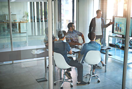 These numbers are strong. Shot of a young businessman giving a presentation in the boardroom.