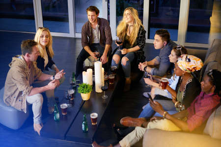 With friends like these, its always a good time. Shot of a group of friends having fun at a nightclub.の写真素材