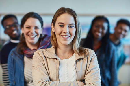 Were going to thrive in our future careers. Portrait of a group of university students standing together at campus.の写真素材
