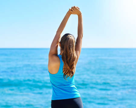 Every day is a new challenge and adventure. Shot of a young woman stretching before her run.