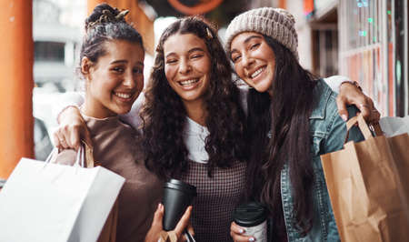 Nothing can come between us. Cropped portrait of an attractive group of sisters bonding together during a shopping spree in the city.の写真素材