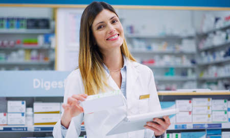 This one comes highly recommended. Cropped shot of a female pharmacist working in a chemist.の写真素材