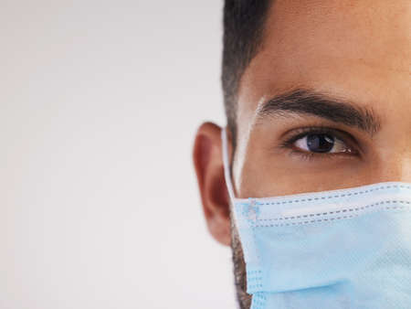 Wear your mask because no one is invincible. Cropped shot of an unrecognizable nurse standing alone...
