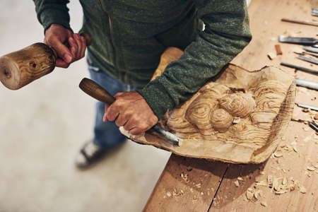 He can carve just about anything. Cropped shot of an artist carving something out of wood.