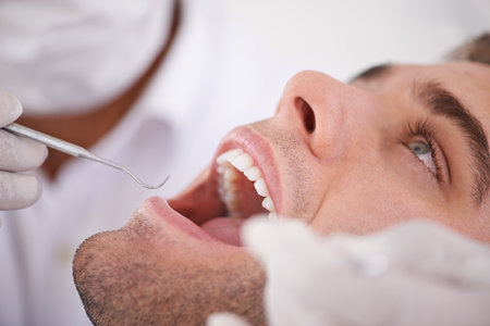 Open wide.... Cropped shot of a young man at the dentist.の写真素材