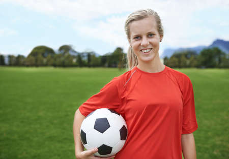 In it to win. Shot of a young female soccer player holding a soccer ball.