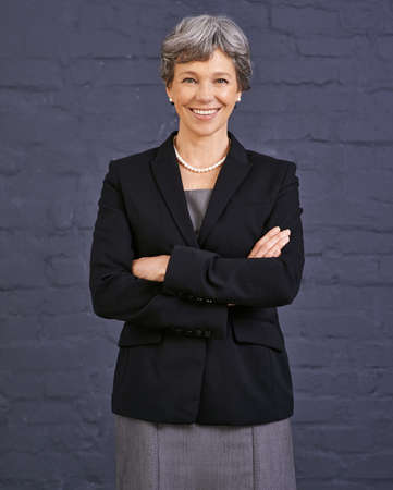 Confident about her success. Portrait of a happy senior businesswoman smiling at the camera.