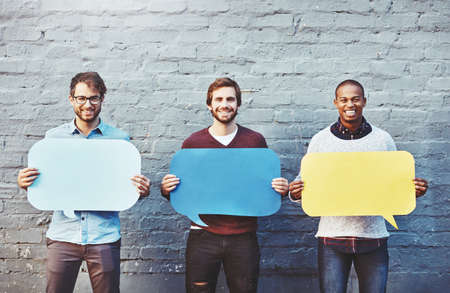 Theyve got some thoughts to share. Portrait of a group of young men holding speech bubbles against a...