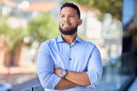 Goals are set to be met. Cropped shot of a handsome young businessman standing outside and looking...