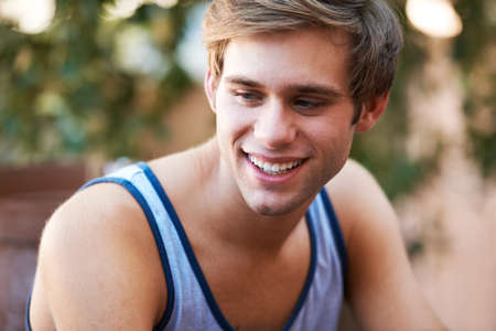 Confident in his style. Handsome young teen smiling while looking away.