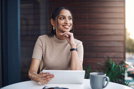 Shes full of ideas. Cropped shot of an attractive young businesswoman using her tablet while working...