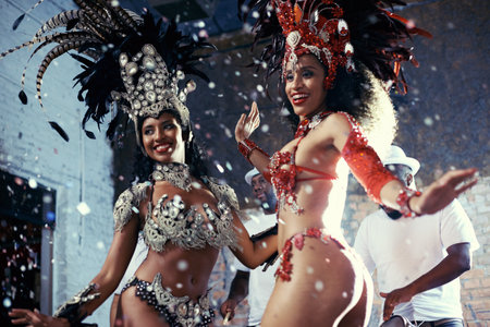 Samba. Shot of two beautiful samba dancers performing in a carnival.の写真素材